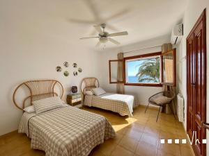 a bedroom with two beds and a window at VH CostaBlanca - EVA in Benissa