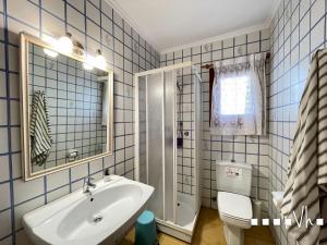 a blue tiled bathroom with a sink and a toilet at VH CostaBlanca - EVA in Benissa +69 photos