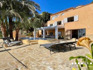 a patio with a table and chairs next to a building at VH CostaBlanca - EVA in Benissa