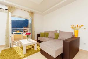 a living room with a couch and a table at Apartments Blue Sea in Kotor