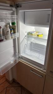 an open refrigerator with its door open and food inside at Mara Ferienwohnung in Schlüsselfeld