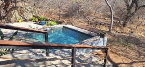 an overhead view of a swimming pool on a deck at Tjhora Sunset Cottage in Cambridge +50 photos