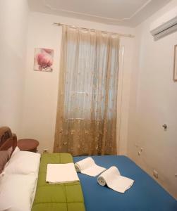 a bedroom with a bed and a window at Fatima House in Rome