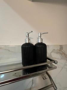 two black cylinders are sitting on a metal shelf at Arcane viewfinder homestay in Gangtok +89 photos