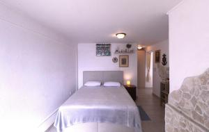a bedroom with a bed with two pillows on it at Sea view apartment Umag 2 in Umag