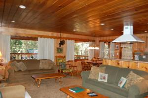a living room with two couches and a table at Deer Den in Wawona