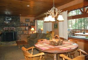 a living room with a table and a couch at Deer Den in Wawona