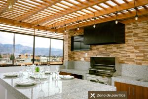 a kitchen with a table with wine glasses on it at Baños del Inca Premium Hotel in Los Baños del Inca