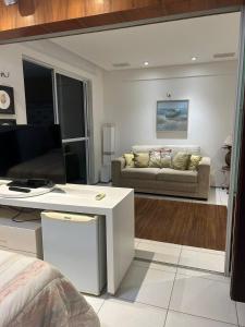 a living room with a couch and a table at Apartamento com cobertura no Portamaris Resort in Aquiraz