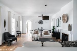 a living room with white furniture and a fireplace at Villa Seascape, Beachfront Living in the Greek Riviera Porto Heli in Porto Heli
