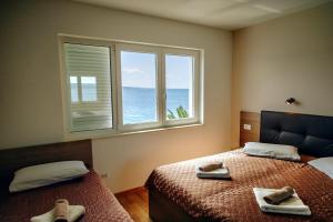 Posteľ alebo postele v izbe v ubytovaní Apartmens Beach house