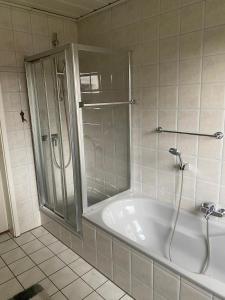 a bathroom with a shower and a bath tub at Haus Datteln in Datteln +4 photos