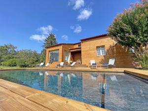 a swimming pool with chairs and a house at Maison rénovée avec piscine privée, 3 chambres à Calès - FR-1-824-8 in Calès