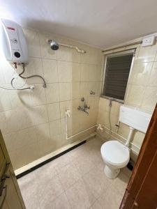 a bathroom with a toilet and a shower at Shritik Homestay in Ratnagiri +6 photos