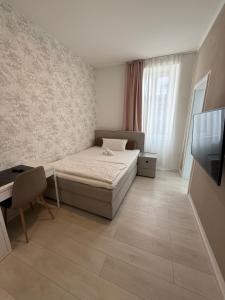 Postel nebo postele na pokoji v ubytování Hotel Astra