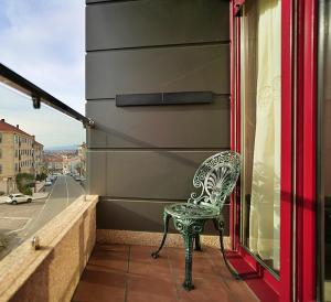 a chair sitting on the balcony of a building at GALIHOST - Apartamento con terraza en Barrantes in Ribadumia