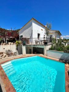 a swimming pool in front of a house at Casa Limón in Palma de Mallorca