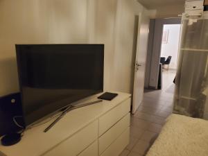 a flat screen tv sitting on top of a dresser at juvignac nono in Juvignac +9 photos