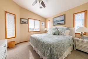 a bedroom with a bed and a ceiling fan at Duck R Way in Duck +102 photos
