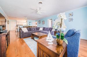 a living room with a couch and a table at Landing Pad in Kill Devil Hills