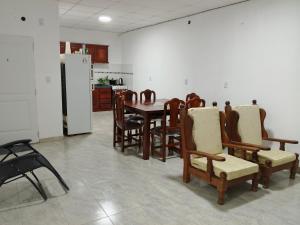 a dining room with a table and chairs and a refrigerator at LaToscana in Las Lomitas