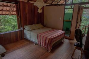 a bedroom with a bed in a room with windows at Suíte Curuaçu in Santarém +39 photos