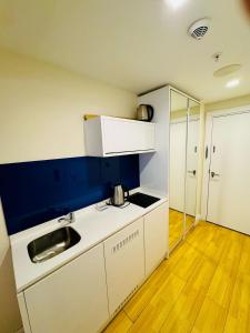 a small kitchen with a sink and a counter top at Orbi city dream city block A in Batumi