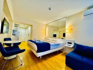 a bedroom with a bed and a table and a couch at Orbi city dream city block A in Batumi