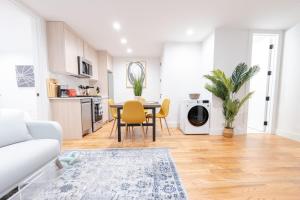 ブルックリンにある323-1 Spacious 2BR Williamsburgのテーブルと椅子、キッチンのあるリビングルーム
