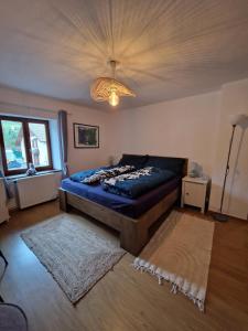a bedroom with a bed and a chandelier at Chevaux au Soleil in Fresse