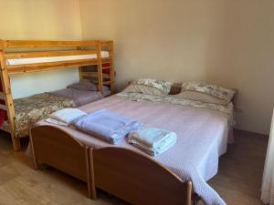two beds in a room with two bunk beds at Casa Del Sole in Pimonte +4 photos