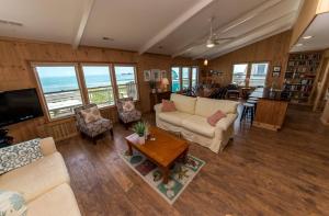 a living room with a couch and a table at Breakaway in Duck