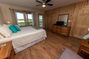 a bedroom with a bed and a dresser and a television at Breakaway in Duck