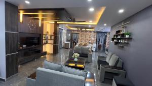 a large living room with couches and a television at Khaleel Manzil Luxe Stays in Hyderabad