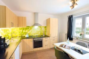 a kitchen with wooden cabinets and a table in it at Murg im Schwarzwaldhäusle in Freudenstadt +9 photos