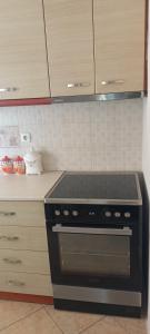 a kitchen with a stove top oven in a kitchen at Rosemary apartment in Eretria +13 photos