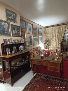 a living room with a desk and a room with a couch at MAMY PENTHOUSE in Palermo