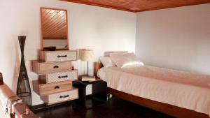 a bedroom with a bed and a mirror on the wall at ZOE in Keramoto
