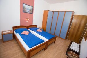 a bedroom with a bed with two pink pillows on it at Apartments Meri - 1 in Lopar