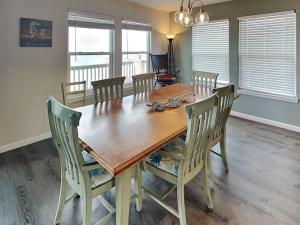 a dining room with a wooden table and chairs at Frisco- Flats in Rockport