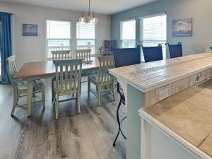 a dining room with a table and chairs at Frisco- Flats in Rockport +26 photos