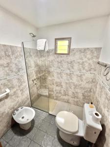 a bathroom with a toilet and a shower at Apart Las Carretas in El Calafate +71 photos