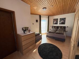 a bedroom with a bed and a wooden ceiling at Wildneschd - Zentral & Schwarzwald Plus inklusive in Bad Wildbad