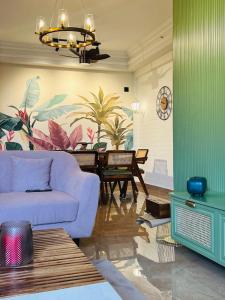 a living room with a couch and a table at Cozy 3 BHK fully furnished apartment in Cochin in Kakkanad