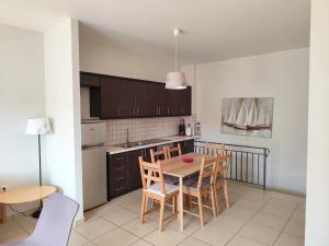 a kitchen with a table and chairs in a room at Syvota family maisonette in Sivota