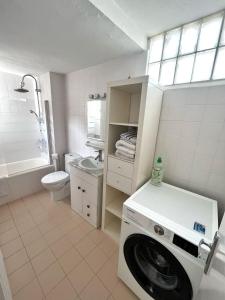 a white bathroom with a washing machine in it at Casa Limón in Palma de Mallorca