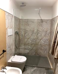 a bathroom with a shower and a toilet and a sink at San Carlo 104 in Caserta