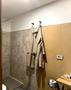 a coat hanging on a wall in a bathroom at San Carlo 104 in Caserta
