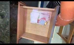 a person is holding a picture in a wooden box at Sobrado para até 16 pessoas px ao centro in Porto De Galinhas