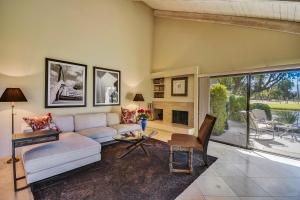 a living room with a couch and a table at Elegant Lakeside Villa in Rancho Mirage
